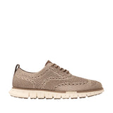 Taupe Cole Haan Men's ZERØGRAND Stitchlite™ wingtip oxfords with a knit upper and a light beige segmented sole.