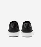 Back view of two black Stitchlite slip-on sneakers with white soles. Each has a black leather-like heel patch with an embosse