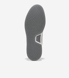 Dark gray sneaker sole with hexagonal tread pattern, light gray trim, and a tan upper. White Cole Haan Grand.ØS logo on the a
