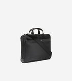 Black slim briefcase with fabric body, leather-like trim, two top handles, a detachable black shoulder strap, and silver-tone