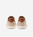 Pair of beige knit slip-on sneakers with light cream soles and brown leather-like heel tabs featuring a 'CH' logo.