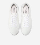 A pair of white Cole Haan GrandPrø All Day Court Sneakers with mesh uppers, smooth toe caps, white laces, and white soles.