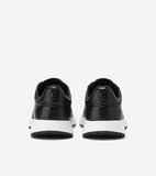 Pair of black leather sneakers with white soles and embossed 'CH' logos on the heels.