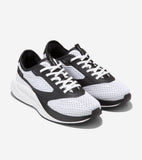 Pair of white mesh sneakers with black overlays, white laces, black collar, and thick white sculpted midsoles with black outs