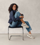 Cream knit platform sneakers with light beige suede accents, gold-toned snakeskin side panels, white soles, and braided trim.