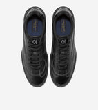 Pair of black leather low-top sneakers with white stitching, black laces, silver-toned 'CH' logo on tongue, and blue insoles