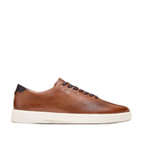 Brown leather low-top men's sneakers with perforated detailing, dark brown laces, a dark brown heel tab, and an off-white sol