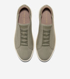 Olive green knit slip-on sneakers with elastic criss-cross laces and cream soles.