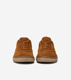 Pair of cognac brown suede low-top sneakers with matching laces and light brown rubber soles with visible stitching.