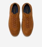 Pair of brown suede lace-up sneakers with matching laces, brown leather trim around the collar and sole, and light brown rubb