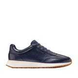 Navy blue Cole Haan GrandPrø Luxe Mile slip-on sneakers with an off-white midsole and gum-coloured outsole.