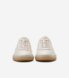 A pair of off-white leather sneakers with matching laces and tan rubber soles. The soles have a ribbed texture.