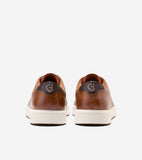 Pair of brown leather low-top sneakers with dark brown heel tabs, silver-toned 'CH' logos, and thick cream soles.