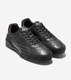 Black leather and suede sneakers with black laces, silver-toned tongue logos, stitched side panels, and perforated toe boxes.