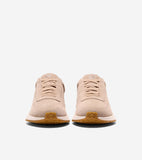 Pair of light tan suede slip-on sneakers with elastic laces, a G logo on the tongue, white midsoles, and brown textured rubbe