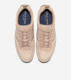 Pair of tan suede lace-up sneakers with textured side panels, dark blue insoles, and subtle embossed 'CH' logo.
