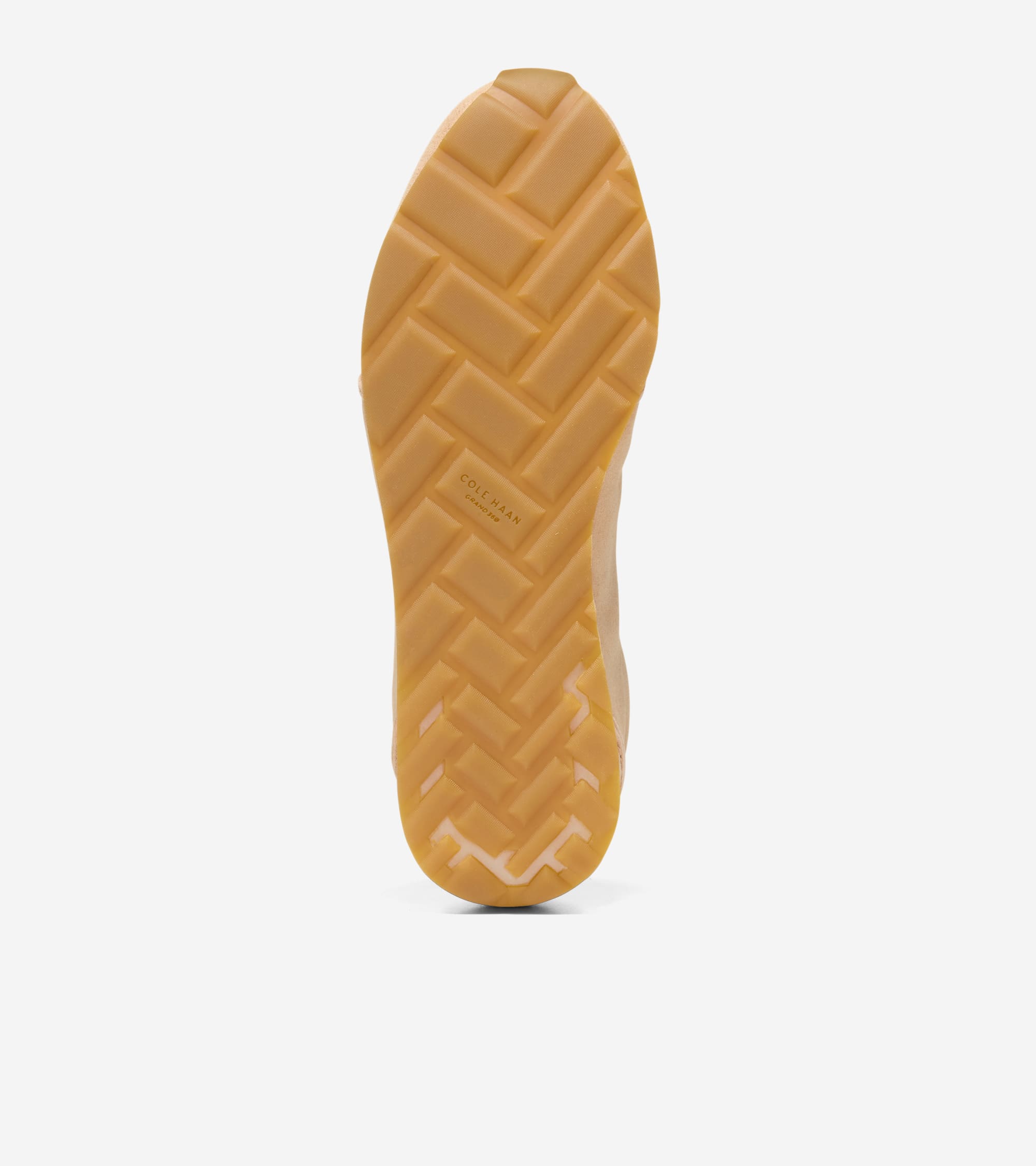Tan rubber sneaker sole with a herringbone tread pattern and 'COLE HAAN GRANDPRØ' branding.