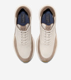 Pair of off-white sneakers with light brown suede on the toe, sides, and collar. White soles, dark blue insoles with gold-ton