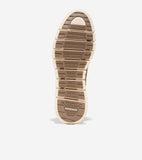 Shoe sole with segmented, flexible design. Creamy beige outer sole, dark brown inner sole with textured grip. Cole Haan logo