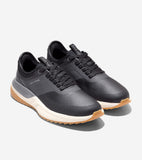 Pair of black Cole Haan golf shoes with textured uppers, smooth overlays, light gray side accents, cream midsoles, and gum ou