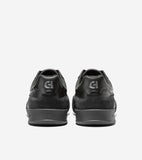 Pair of black sneakers, seen from the back. Smooth heel counter with debossed 'CH' logo, suede-like lower upper, and black so