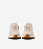 Pair of light beige suede slip-on sneakers with elastic laces, white midsoles, and tan gum rubber outsoles with textured toes
