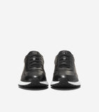Black leather slip-on sneakers with decorative black laces, white midsoles, and black textured rubber outsoles.
