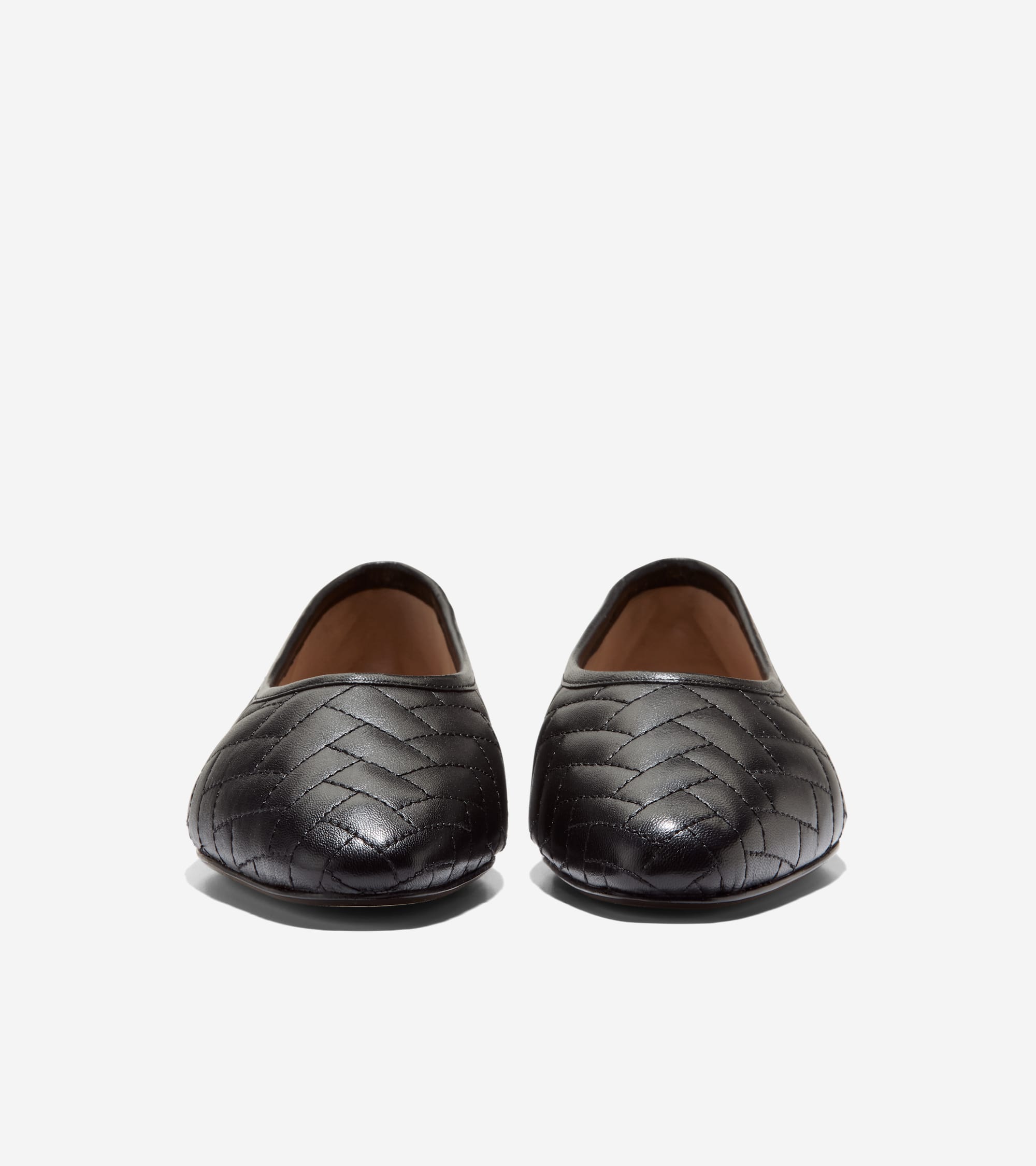 A pair of black leather ballet flats with a chevron quilted pattern across the upper.
