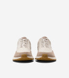 Pair of cream leather and tan suede sneakers with cream laces, off-white midsole, and brown patterned rubber outsole.