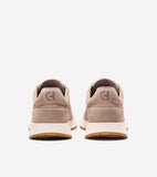 Pair of light tan suede slip-on sneakers, back view. Each heel features a subtle 'CH' logo. Cream midsoles, gum outsoles.