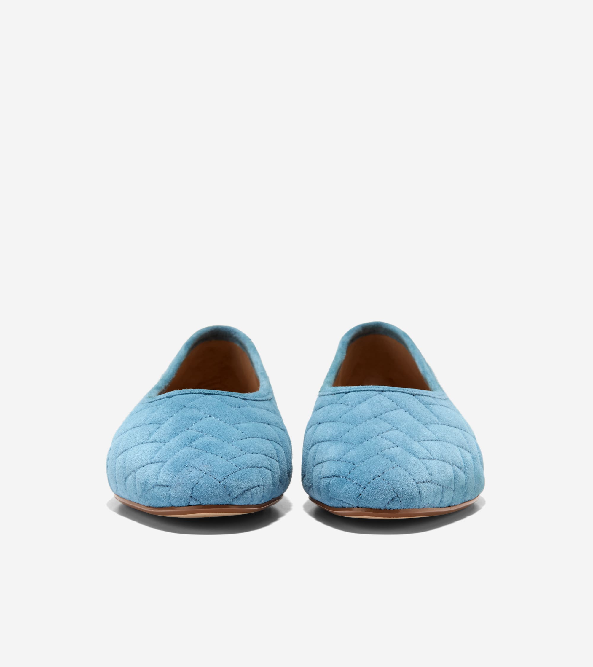 A pair of light blue quilted suede ballet flats with a chevron pattern and tan soles.
