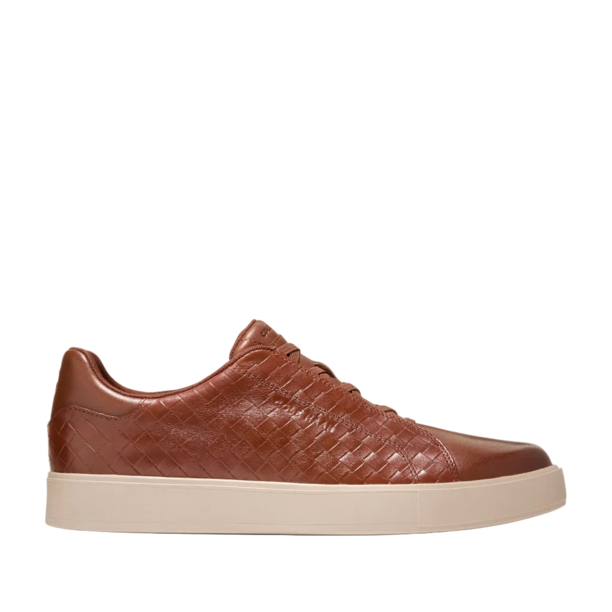 Brown Cole Haan Men's GrandPrø Luxe slip-on sneakers with a woven leather upper and a light beige sole.