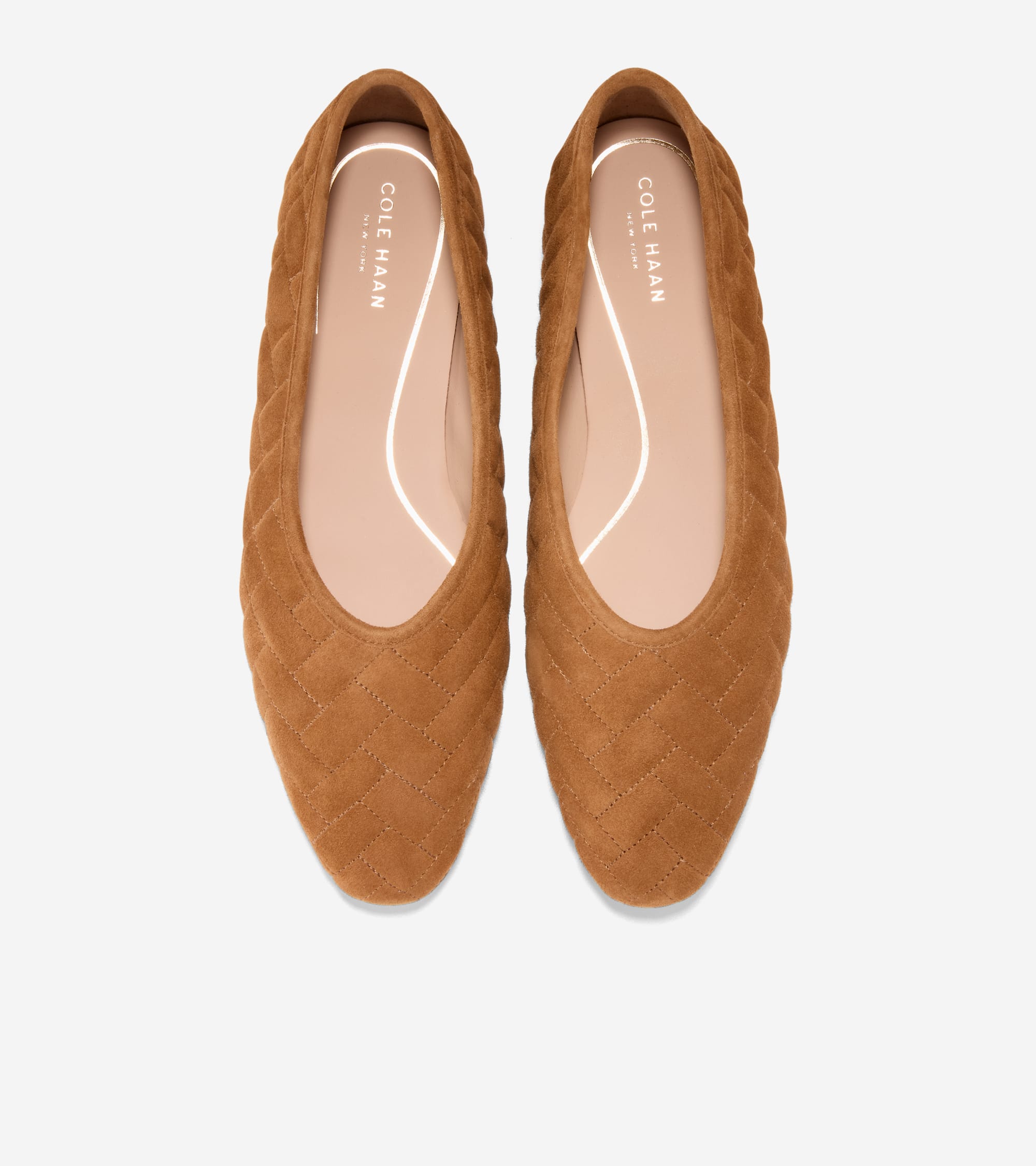 Brown suede ballet flats with a quilted herringbone pattern, pointed toes, and light pink insoles.