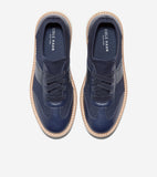 Pair of navy blue knit and leather-paneled lace-up platform sneakers with light tan soles and white stitching.