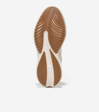 Off-white sneaker sole with brown rubber traction. The toe has curved ribs, and the heel has two smooth leaf-shaped pads with