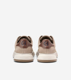 Pair of beige suede sneakers with dark brown glossy 'CH' heel tabs, off-white 'COLE HAAN' midsoles, and brown outsoles.