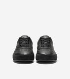 Pair of dark grey leather sneakers with black laces, white contrast stitching, silver-toned logo on tongue, and thick black t