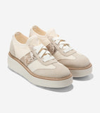 Pair of cream knit mesh platform sneakers with light beige suede accents, snakeskin-patterned side panels, and white laces.