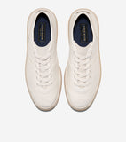 Pair of off-white textured leather-like lace-up sneakers with light tan soles and dark blue insoles with gold-toned branding.