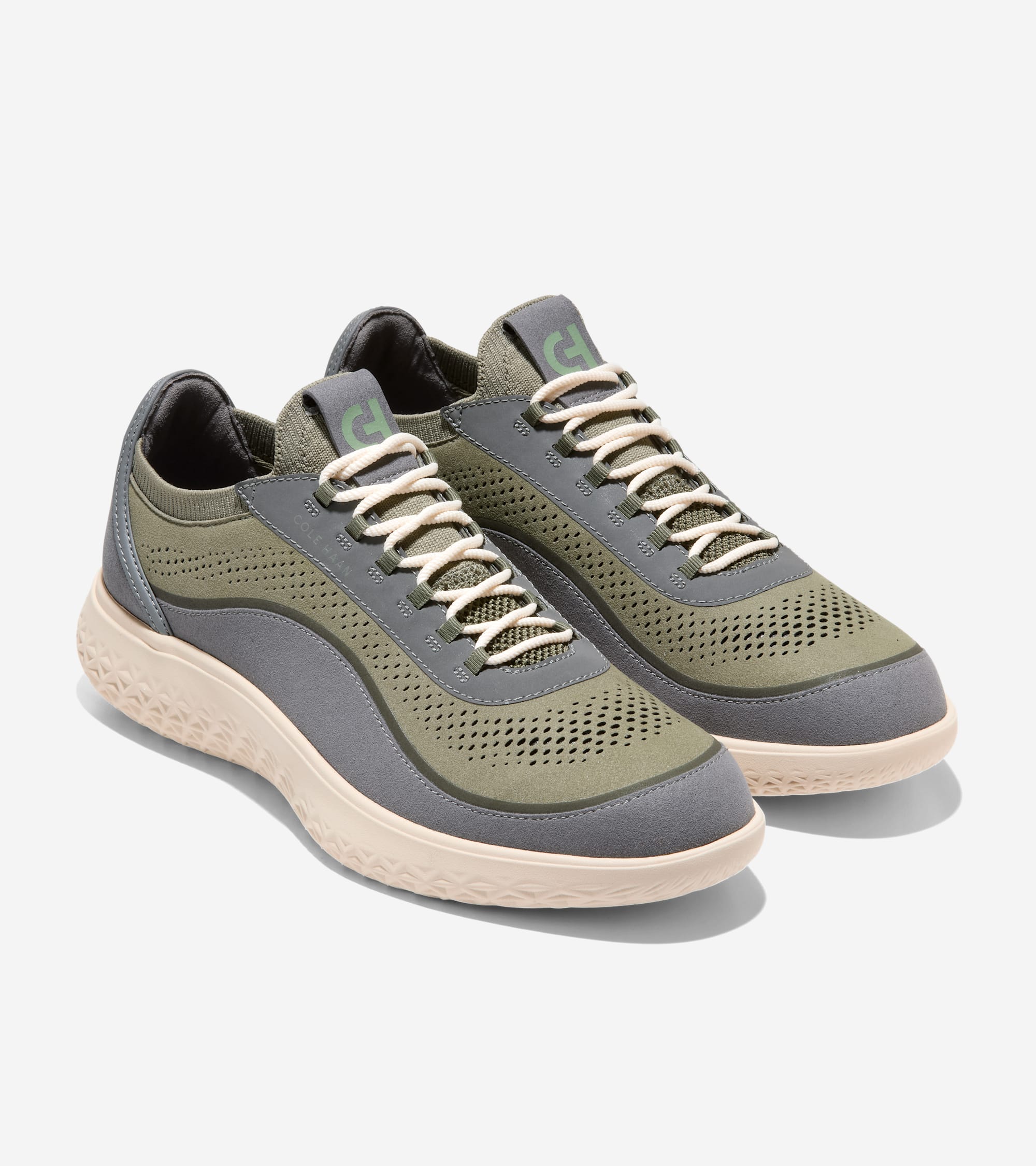 Pair of olive green and dark gray knit sneakers with white laces, green CH logo on tongue, and light beige textured soles.