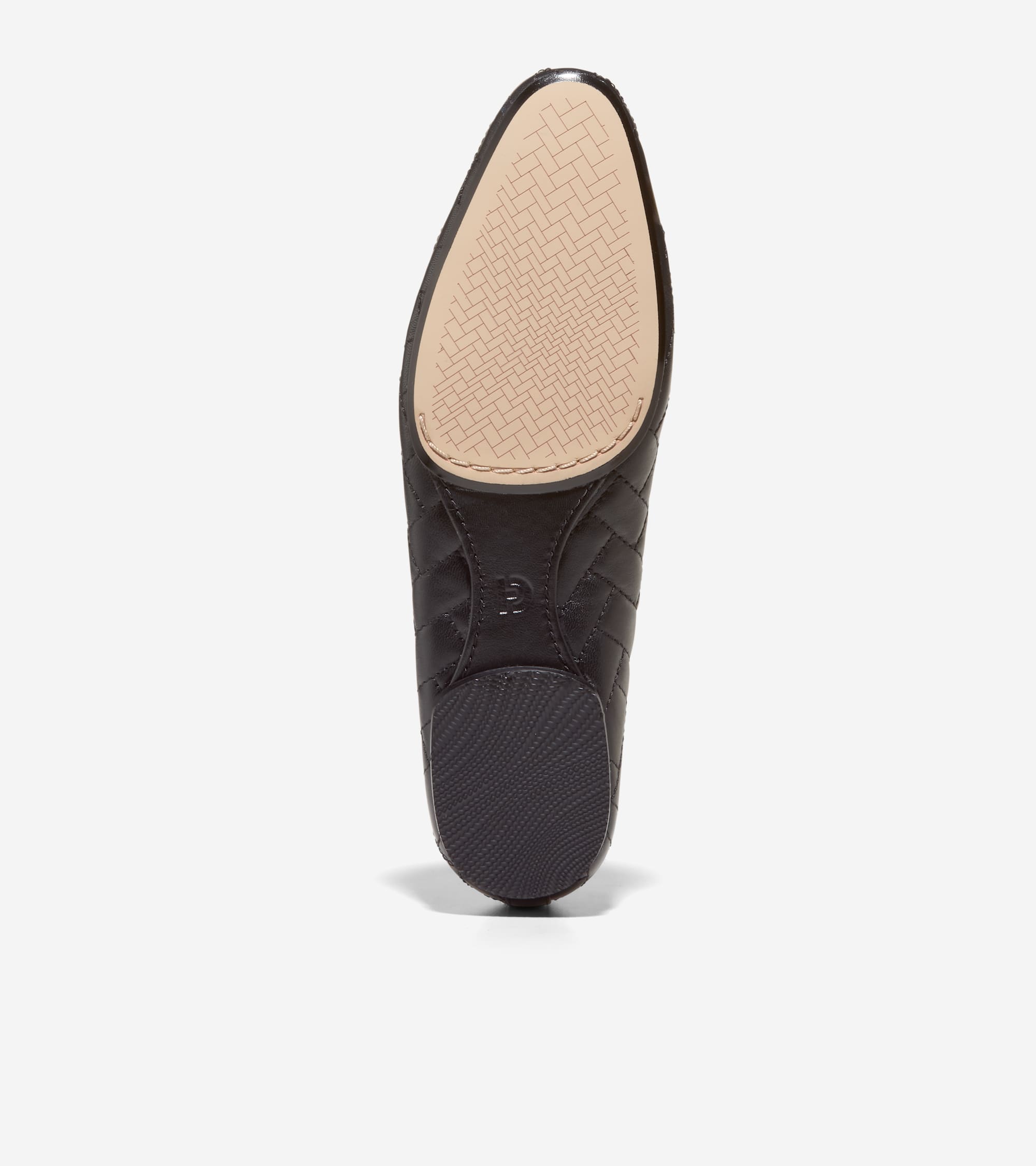 Black quilted ballet flat, seen from the sole. Features a beige woven-patterned toe pad and a black ridged heel pad.