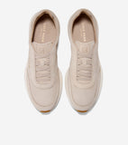 Pair of light beige suede slip-on sneakers with elasticized laces, an embossed CH logo, and thick cream soles with brown toe