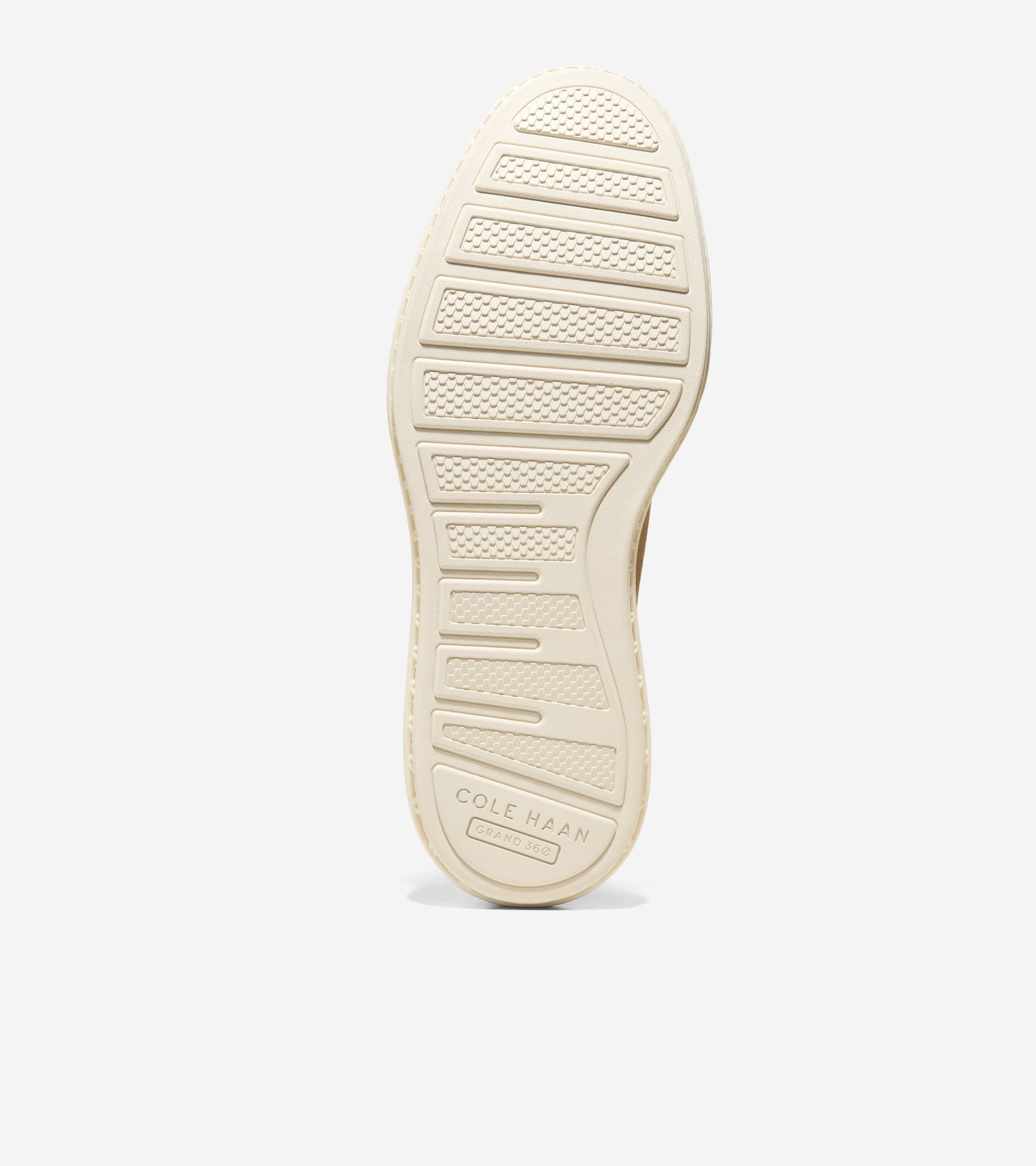 Cream-colored shoe sole with textured rectangular grip patterns and 'COLE HAAN GRAND 360' branding.
