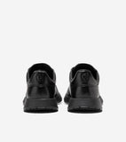 Black leather slip-on sneakers with thick black soles and an embossed 'CH' logo on each heel.