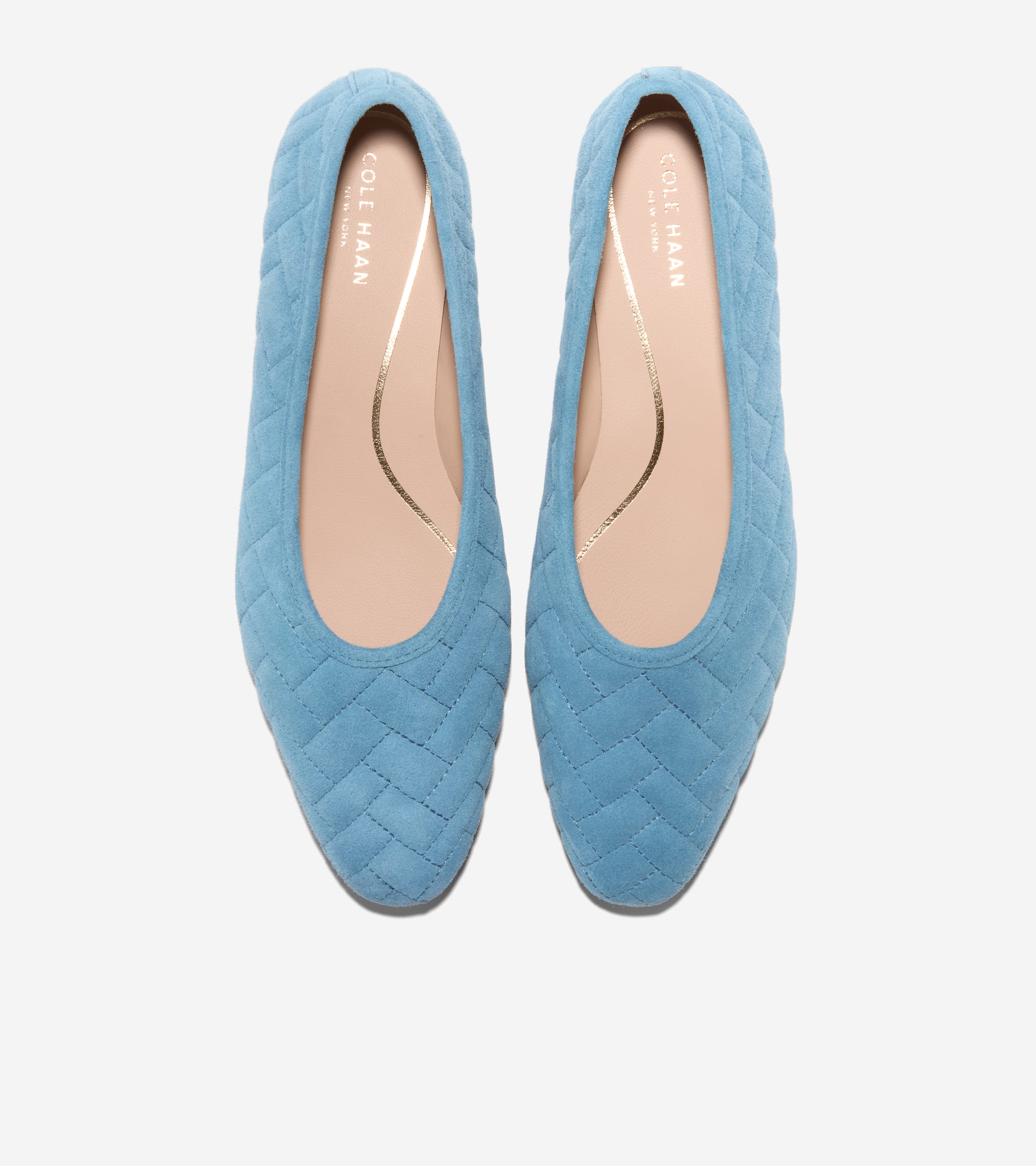 Pair of light blue suede ballet flats with a chevron quilted pattern and pointed toes. Tan insoles feature gold-toned accents