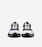 A pair of black and white mesh running sneakers with white laces, black synthetic overlays, and black soles with a white stri