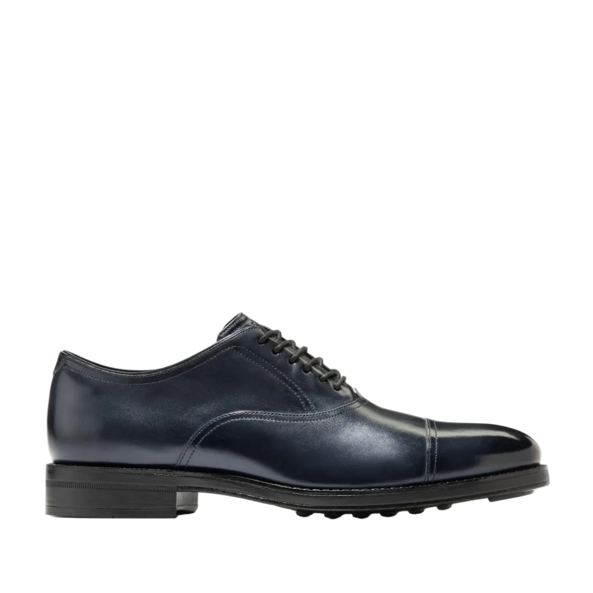 Dark blue Cole Haan men's cap toe Oxford shoe with six eyelets and a polished leather finish.