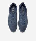 Pair of blue suede low-top sneakers with matching laces, dark blue lining, and gold-toned Cole Haan logo on the insoles.