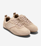 Tan suede low-top sneakers with smooth leather side panels, matching laces, Cole Haan logo on left shoe, and light brown sole