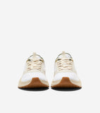 White mesh running sneakers with beige overlays, cream laces, dark green collar, gold-toned eyelets, and light brown gum sole